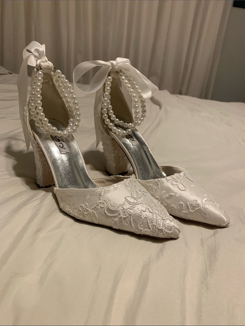 Lacy white bridal shoes with pearl and lace